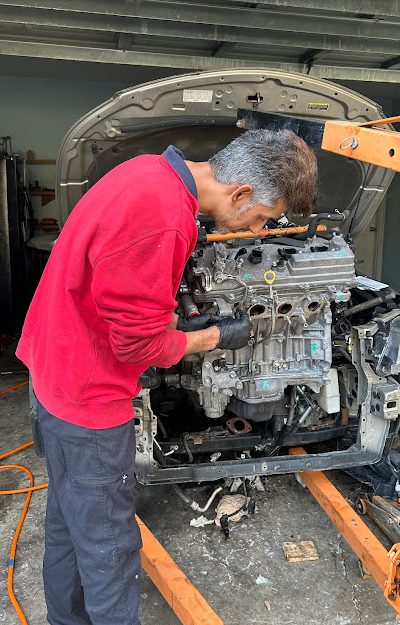 Technician focused on engine repair in a residential workspace